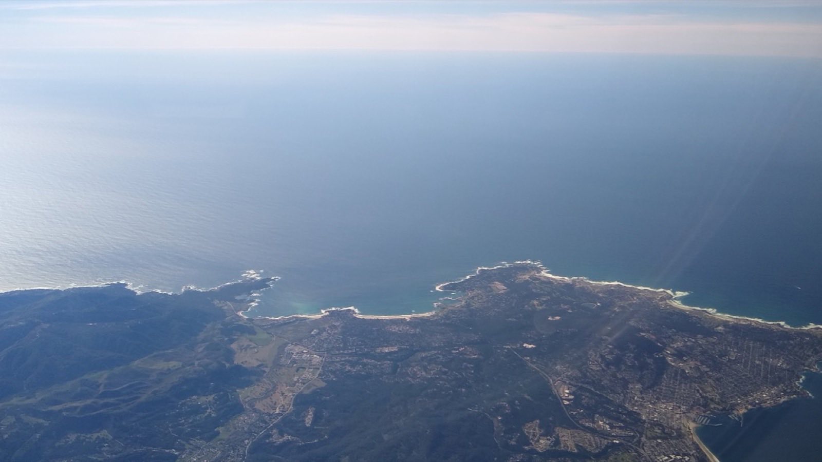 Aerial view of the Monterey Peninsula from Pacific Grove to Carmel, where Rayne Technology Solutions supports local organizations