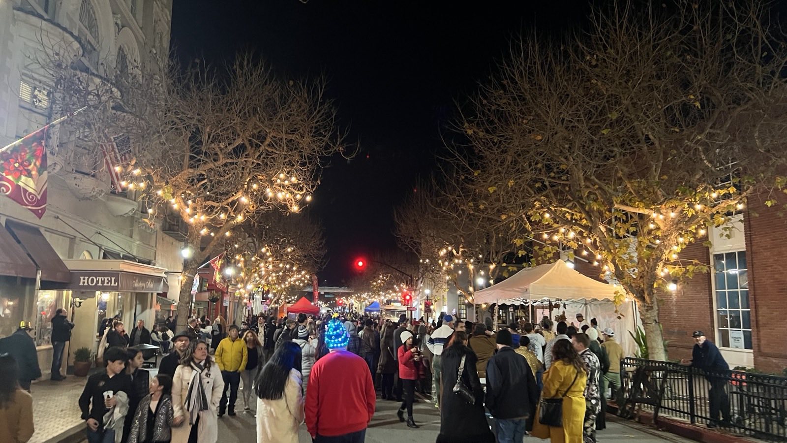 Crowd on Alvarado Street in downtown Monterey during a nighttime community holiday event
